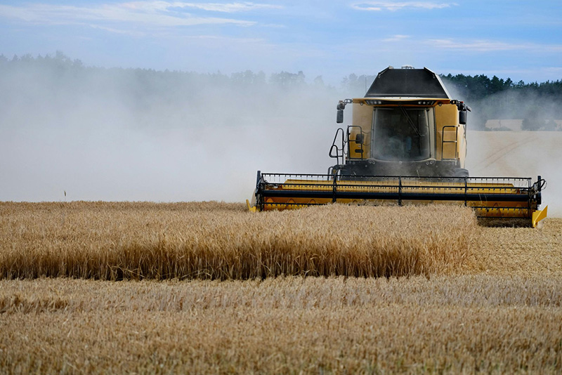Farming equipment harvesting wheat