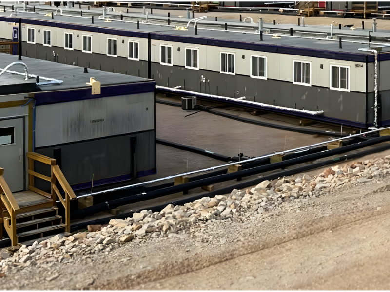 Modular camps lined up on site with gravel foreground