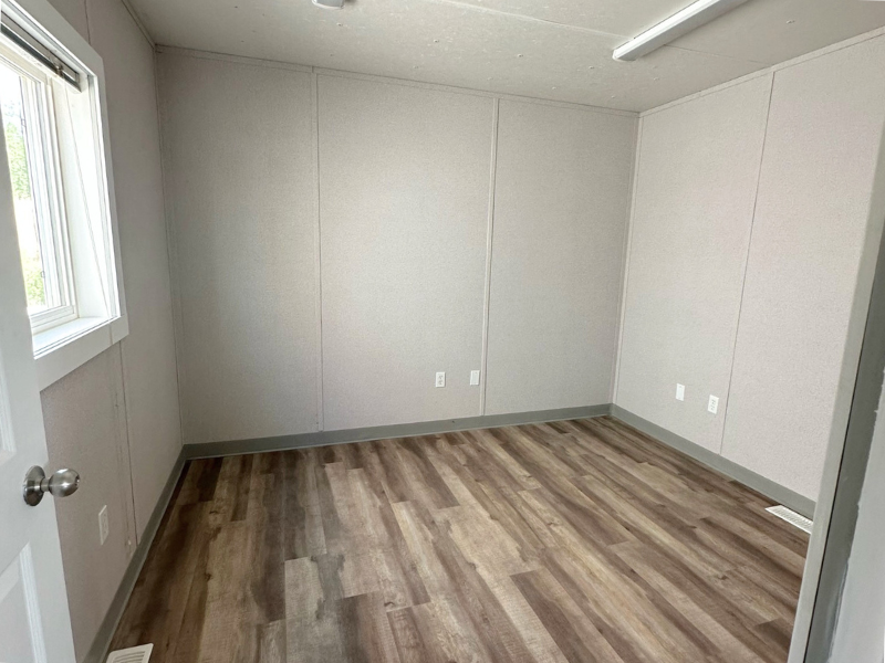 Trailer office with light walls and wood grain flooring