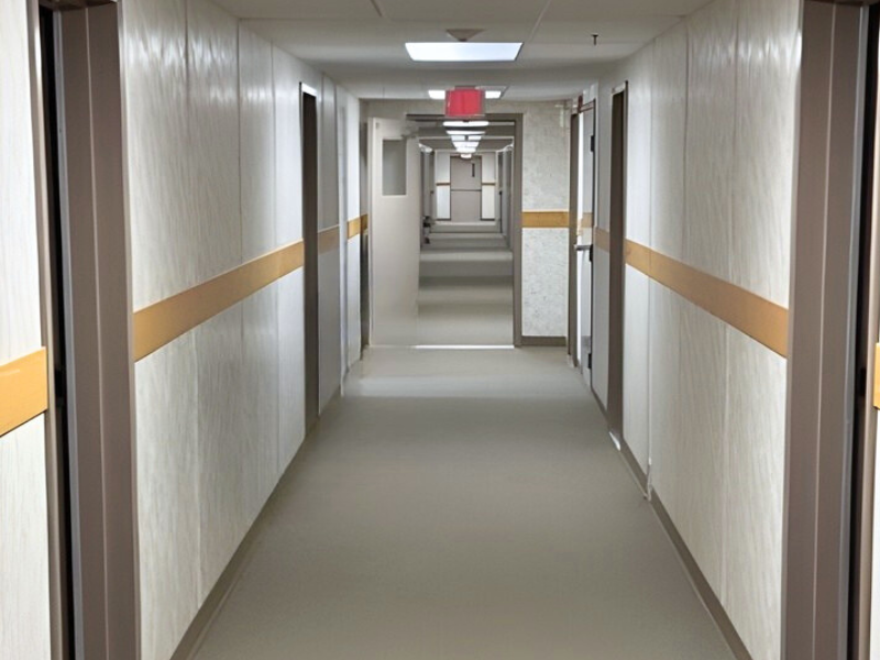 Office complex modular hallway with office doors and grey flooring