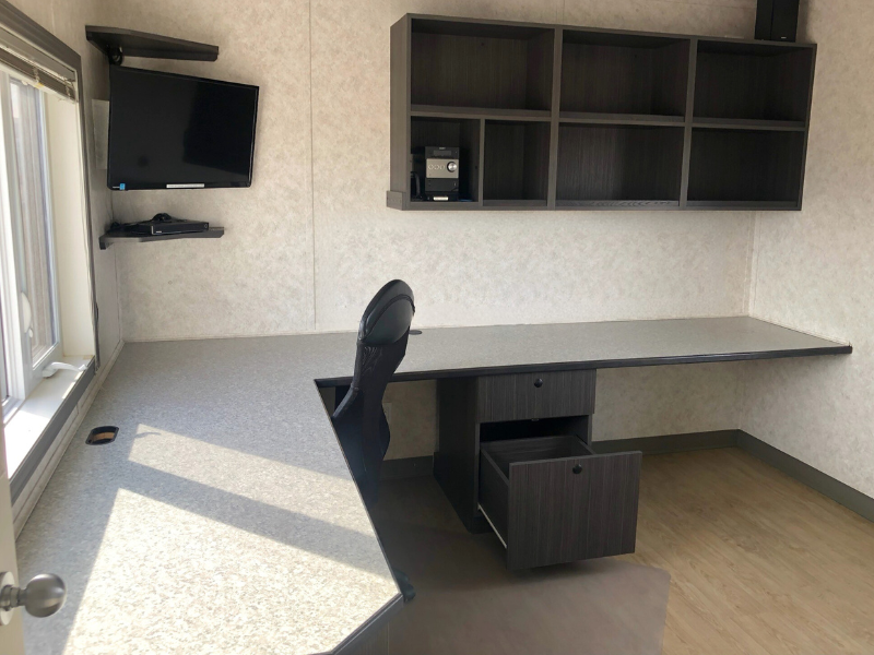 Partitioned modular Office with office furniture light walls and wood grain floor