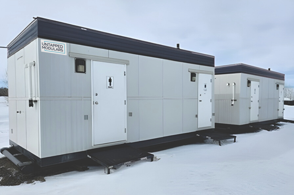 Two modular lavatories on a snow covered ground